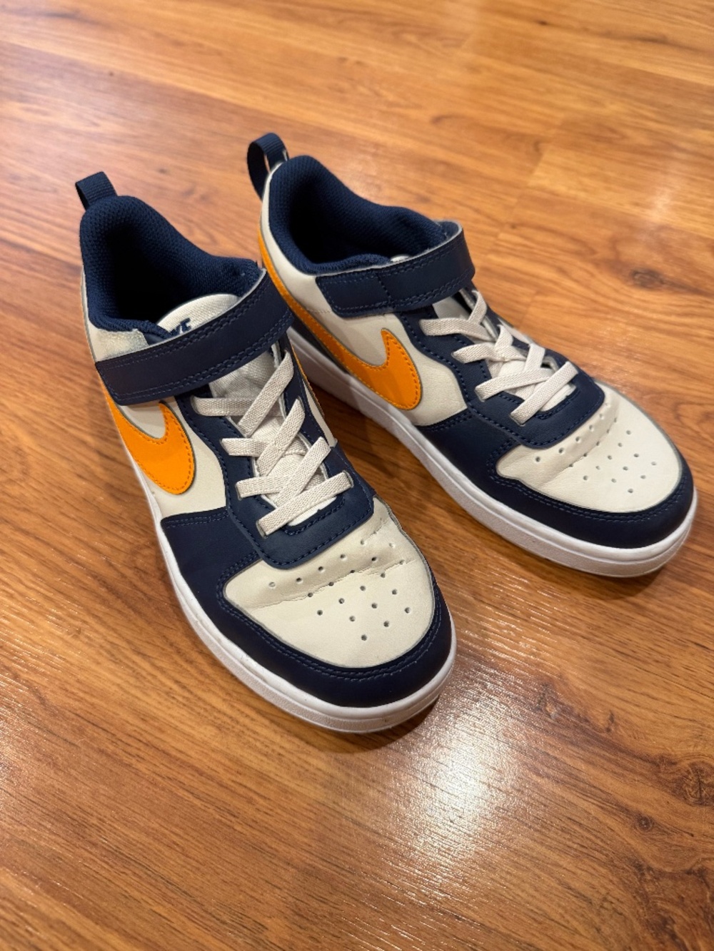 Youth Size 2 Nikes in great condition! navy and yellow